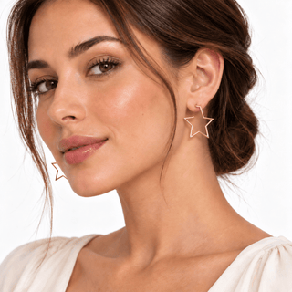 18K Solid Gold Polished Open Star Thin Tube Post Earrings on a Model