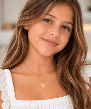 18K Solid Yellow Gold Polished Angel Charm Pendant on a girl